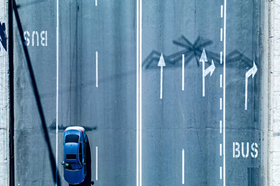 Bird's eye view of multi-lane road with dedicated bus lanes.